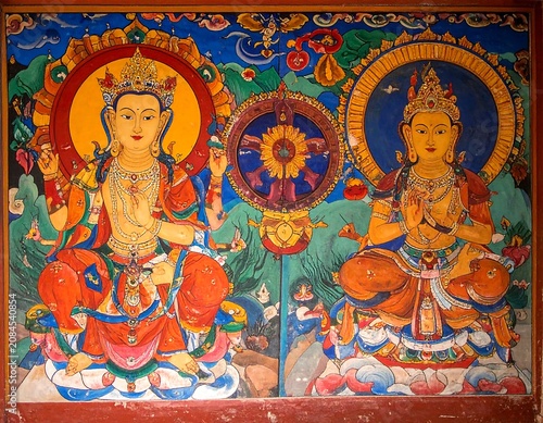 Vibrant mural depicting two seated figures with halos