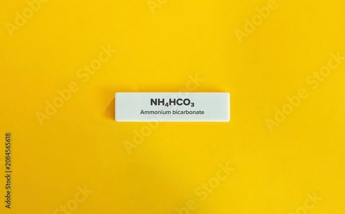 Bild auf Leinwand Ammonium bicarbonate chemical formula NH4HCO3 on yellow background