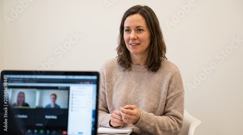 Woman participating in a video conference call with colleagues