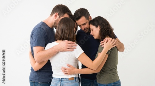 Group of friends embracing in a circle showing support and unity