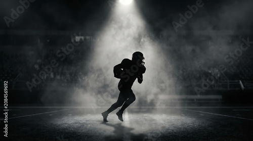 Dynamic American Football Player Silhouette Running in Stadium Spotlight - Sports Marketing & Performance