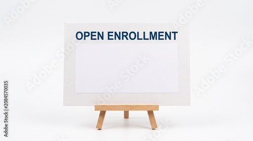 Open Enrollment sign on a wooden easel with blank space for text