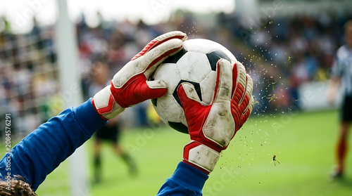 Professional Goalkeeper Catching Soccer Ball. Dynamic Football Match Save Action for Sports Marketing, Training, and Athletic Performance