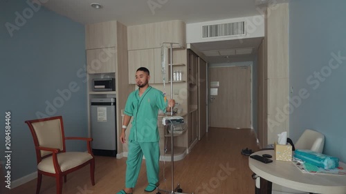 Male patient resting and recovering in a modern hospital room with IV drip, medical bed, and healthcare equipment, representing treatment, recovery, and medical care.