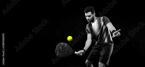 Padel tennis player. Man athlete with paddle tenis racket on black background. Sport concept. black and white