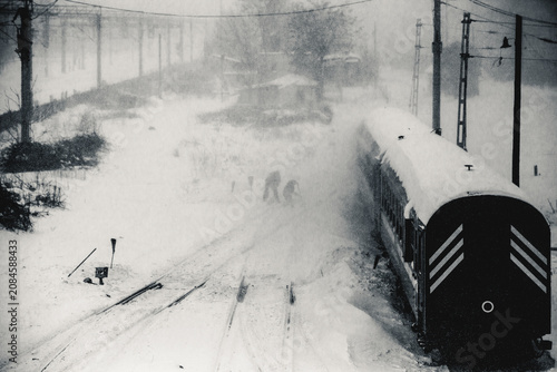 Train operating through a snow blizzard in black and white