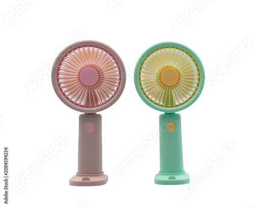 Two portable handheld fans in pastel pink and green on a white background, for cooling off on hot summer days.