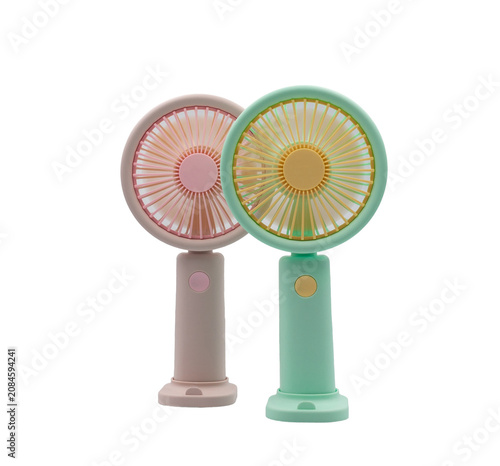Two portable handheld fans in pastel pink and green on a white background, for cooling off on hot summer days.