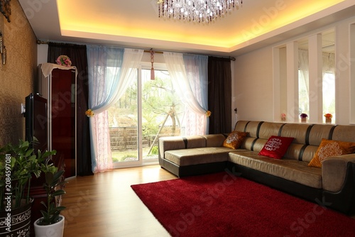 Modern Luxury Living Room Interior with Large Sofa, Crystal Chandelier and Floor-to-Ceiling Windows