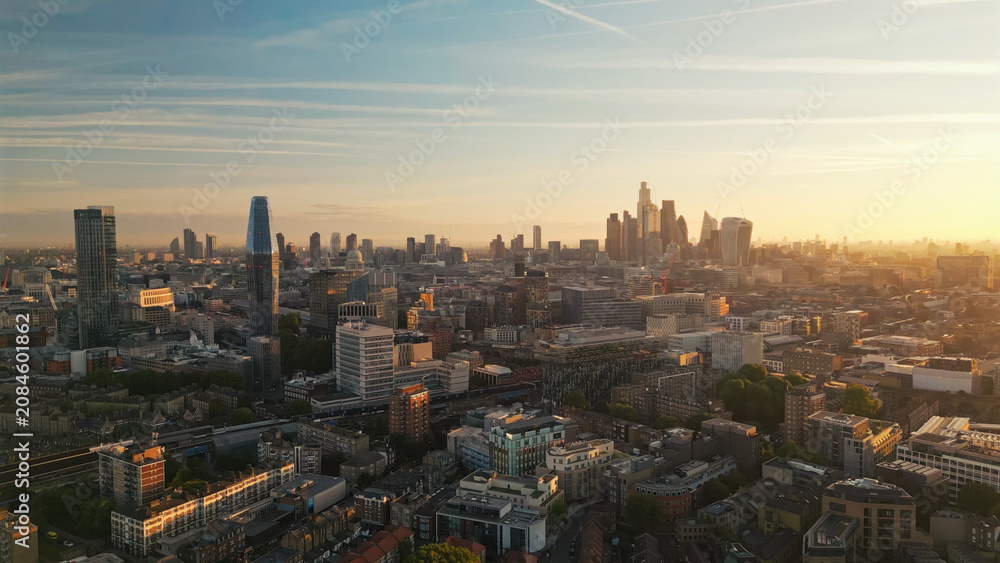 Fototapeta premium London city skyline at dramatic golden sunset aerial view