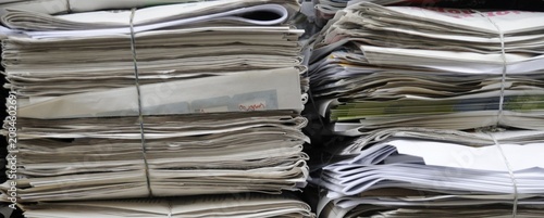 Photos Stacks of newspapers bound with wire, waiting to be recycled