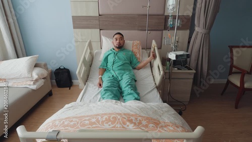 Male patient resting and recovering in a modern hospital room with IV drip, medical bed, and healthcare equipment, representing treatment, recovery, and medical care.