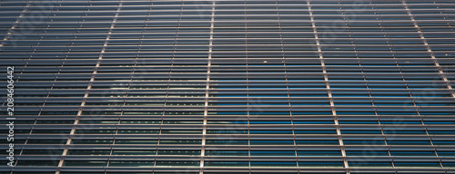 Modern Glass Office Building with a Silver Metal Facade.