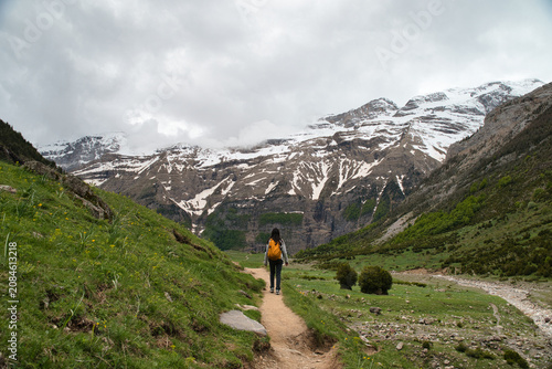 A young girl hiking alone in the Pyrenees, Pineta Valley, Monte Perdido, Camino de los Llanos de la Larri, Aragón, Huesca, Spain	