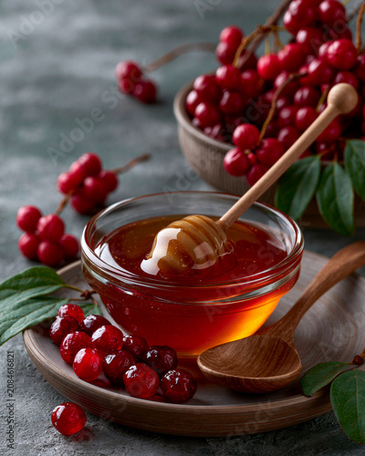 Schisandra berries and honey in a glass jar showcasing Korean medicinal herb vitality longevity and quiet luxury wellness