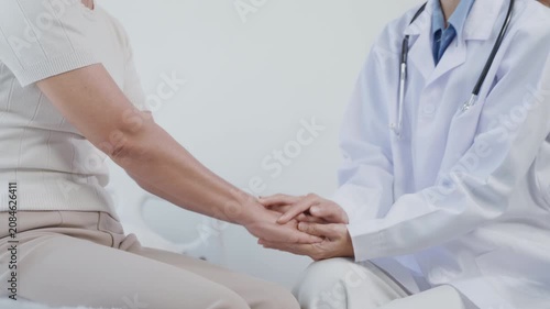 Close-up of a doctor gently holding a patient’s hands to provide reassurance, compassion, and emotional support in a healthcare setting.