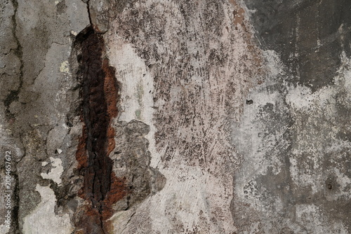 Damaged Plaster Wall with Exposed Corroded Iron Bar