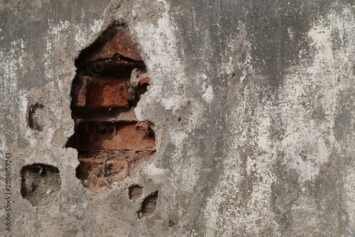Old Peeling Plaster Wall with Exposed Red Bricks Texture