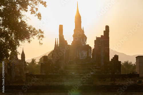 Cuadro en lienzo Ancient Buddha statue at Sukhothai Historical Park during sunset, Thailand