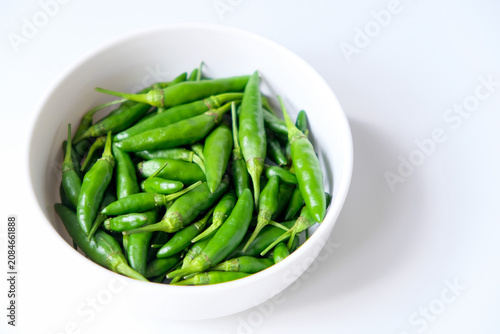 Tableau sur toile Fresh green bird's eye chilies or cabe rawit hijau in a white bowl for culinary