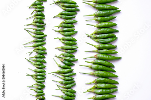 Obraz na plátně Organized horizontal rows of fresh green bird's eye chilies or cabe rawit hijau