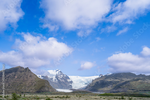 Canvas Print A breathtaking landscape view of the Jokulsarlon Glacier Lagoon in Hofn, Iceland, featuring majestic mountains, glacial ice, and a bright blue sky