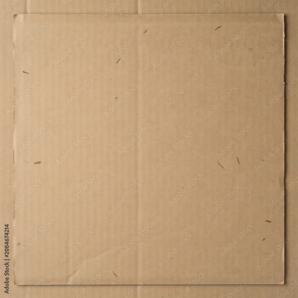 Fototapeta premium Close up texture of corrugated cardboard shipping box surface with visible folds and imperfections