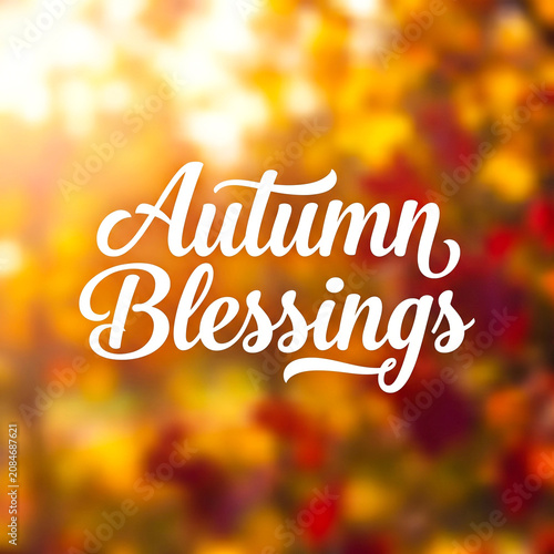 Autumn blessings calligraphy text on a blurred fall foliage background