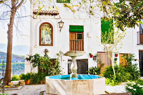 Beautiful Plaza Colorá in the historic Hondillo neighborhood of Lanjarón, with its white houses and flowerpots. Alpujarra region, Granada.