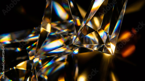Abstract macro background of sparkling diamond crystal prism with light refraction and rainbow flares