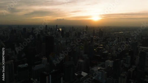 Urban skyline of Bangkok during the golden hour with layered buildings and evening lights. Bangkok, Thailand.