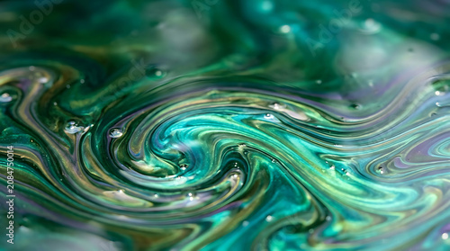 iridescent fluid abstract background, green and teal oil slick texture, nature inspired colors flowing, smooth liquid surface, macro photography style, ultra high resolution