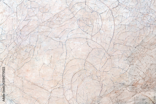 Close-up of an ancient painting surface showing cracked, aged paint and fine lines, revealing vintage texture and artistic decay.