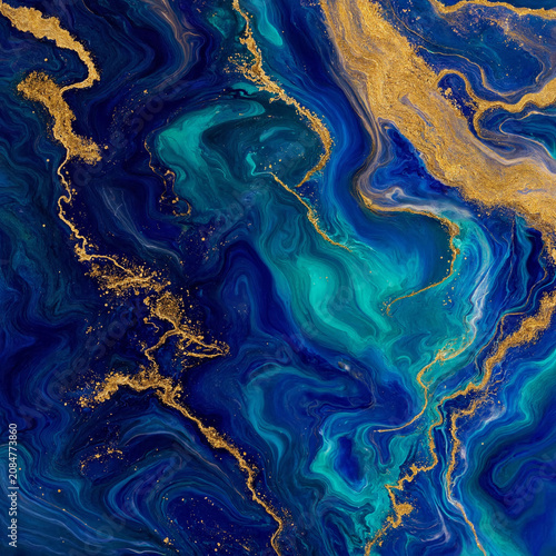 Abstract blue and gold marble ink texture with flowing liquid metallic gold veins background