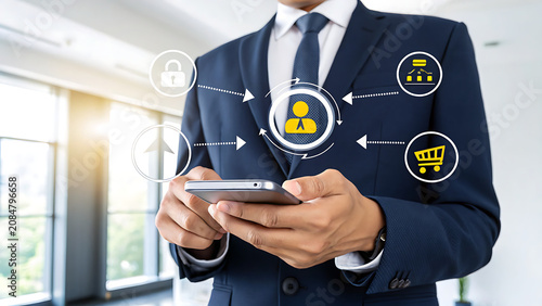 Professional business person using a smartphone in a modern office setting with digital interface icons