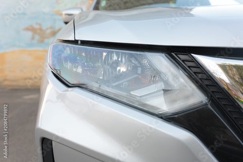 Car Headlight Close-Up on Silver Vehicle