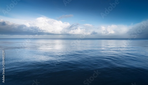 Minimal Cloudy Seascape With Soft Light Reflecting On Calm Water And A Misty Distant Horizon