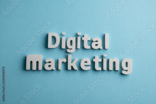 Digital marketing text concept. White letters on a blue background. Online advertising, internet promotion, and business strategy visualization