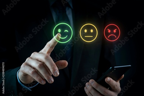 Businessman hand touching a digital holographic interface to select a positive feedback icon