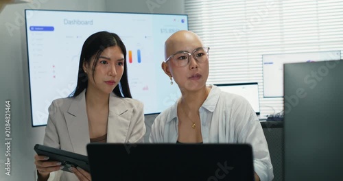 Professional female executive using a digital tablet for data analysis and research. Teamwork and technology integration for successful investment and corporate project planning.