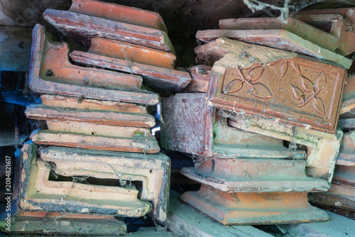 Fotografie a dusty, haphazard stack of salvaged vintage ceramic stove tiles.