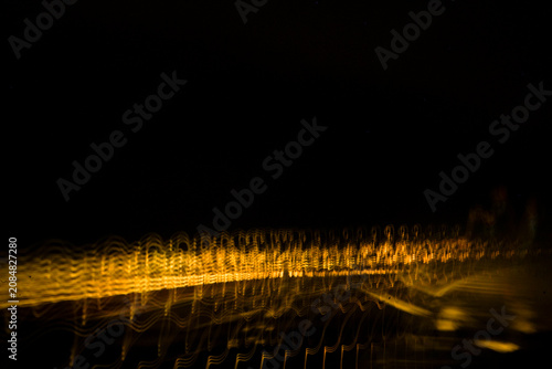 Dynamic dual light trail composition featuring vibrant white waves and gold blur.