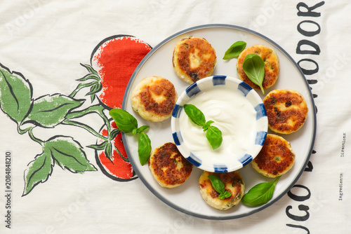 Savory syrniki with sun-dried tomatoes  cheddar and basil. and yogurt-garlic sauce..top veiw