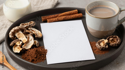 Mushroom cocoa beverage prep with ceramic mug and recipe card