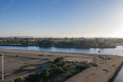 Photography Oakland waterfront showing an old industrial pier extending into the calm bay wa