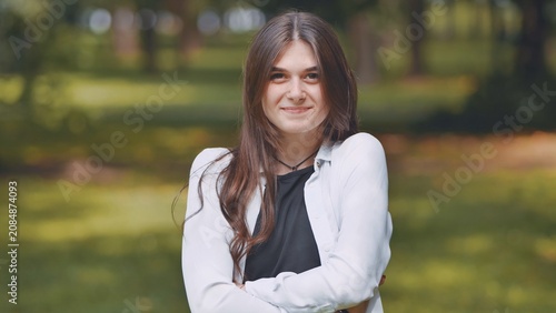 Obraz na plátně Stylish young georgian woman relaxing amid lush greenery, basking in serene park