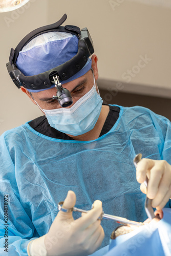 Surgeon performing surgery using medical instruments in operation room