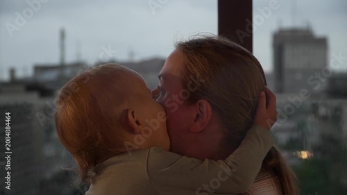 Caucasian mother daughter embracing closely touching foreheads , expressing comfort, trust, emotional support. Useful parenting, family care, bonding, mental wellbeing themes, child having fun mother