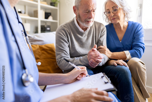 Принти на полотні Doctor giving bad news to senior couple at home visit