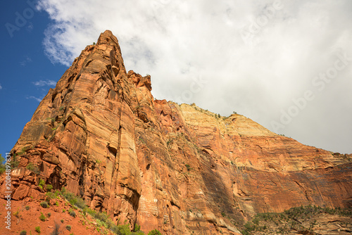 Фотография Angels Landing sandstone monolith rising under shifting clouds in Zion National